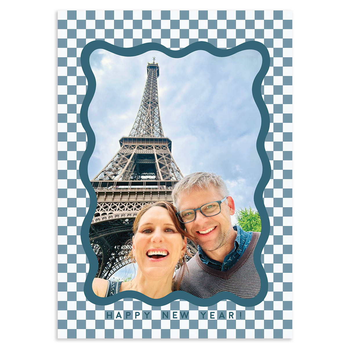 Custom holiday photo card with single vertical image surround by blue scalloped border on a white and blue checkered background