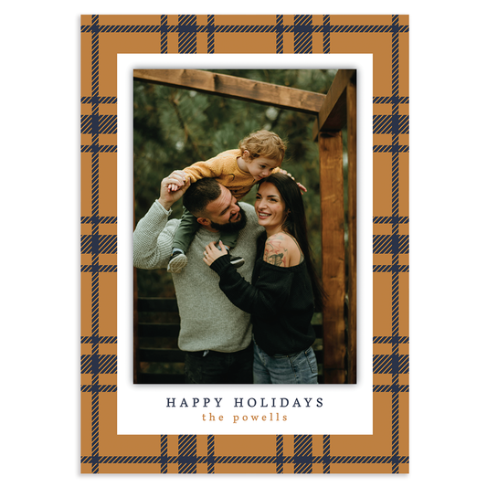 Custom holiday photo card with single vertical image with white border on a gold and navy plaid background