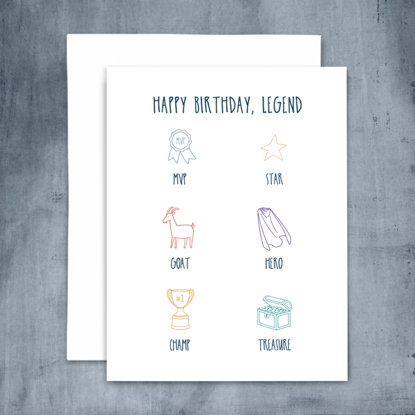 happy birthday legend blank greeting card; blue handwritten font with colorful line drawings of MVP, star, GOAT, hero, champ and treasure; with white envelope shown on blue background