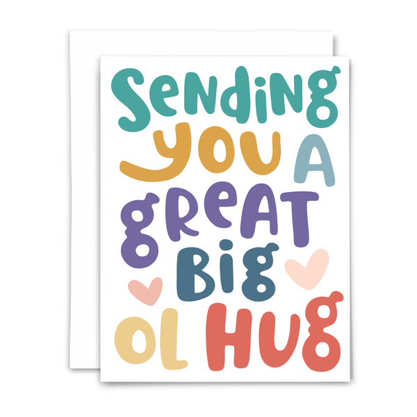 Greeting card with white envelope with colorful bubble text reading Sending you a great big ol hug with two light pink hearts