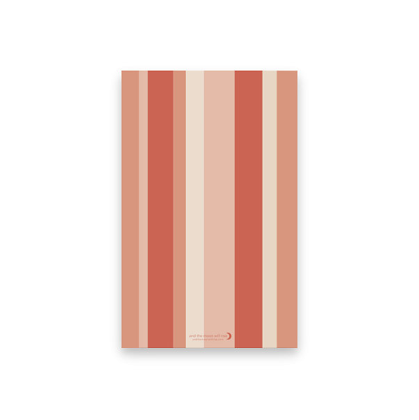 Back cover of dot grid pocket notebook with various width vertical stripes in shades of pink and coral against a white background