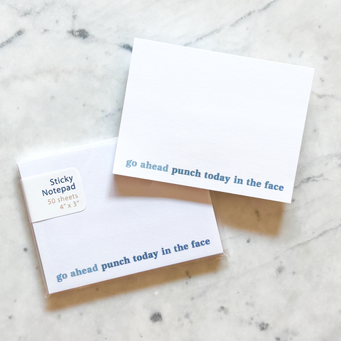 4"W x 3"L sticky notepad; "go ahead ~ punch today in the face" in blue lowercase font along bottom on white background