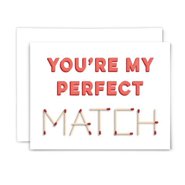 A2 horizontal card with "you're my perfect match" in stamped coral font and "match" spelled out in matchsticks with white envelope on white background