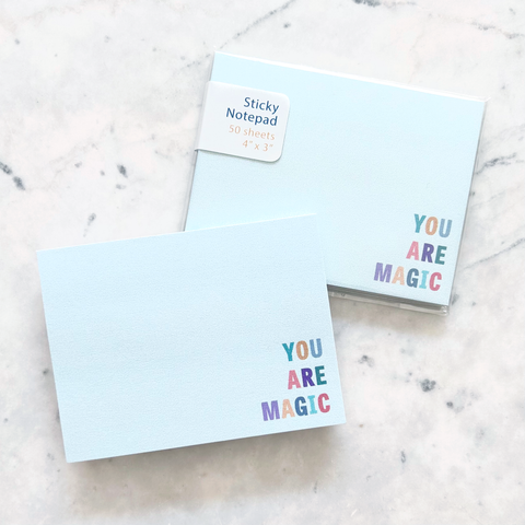 4"W x 3"L sticky notepad; "you are magic" in colorful block letters in lower right corner on light teal background