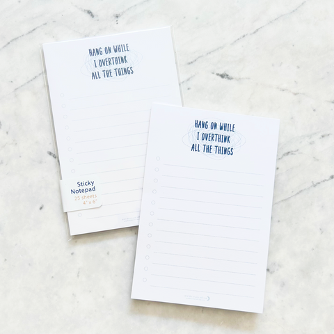 4"W x 6"L sticky notepad; "hang on while I overthink all the things" in navy font atop light blue chaos squiggles at top with 12 horizontal light blue lines for list making on white background