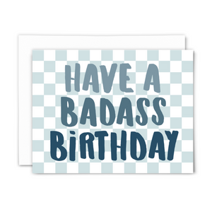 blank greeting card, "have a badass birthday" in chunky blue hand script on light blue checkered background with white envelope