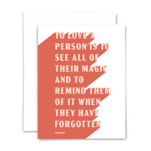 "To love a person is to see all of their magic and to remind them of it when they have forgotten." (Unknown) blank greeting card. Light coral lettering on medium coral and white background; with white envelope