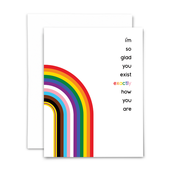 blank greeting card "I'm so glad you exist exactly how you are" in modern black font with updated Pride flag featuring rainbow transgender colors and intersex flag on white background with white envelope