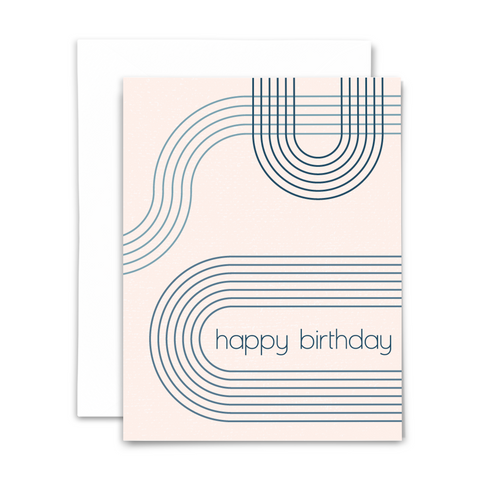 blank greeting card, "happy birthday" in modern blue font on deckled blush background with blue bauhaus-inspired concentric lines; with white envelope