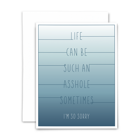 Blank sympathy greeting card: Life can be such an asshole sometimes; I'm so sorry; blue stick font on white to dark blue gradient background with white envelope