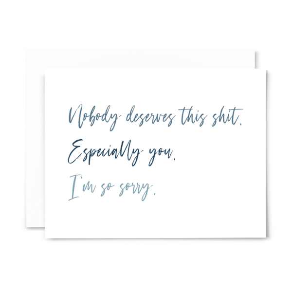 'Nobody deserves this ish. Especially you. I'm so sorry' greeting card with blank interior; blue font on white card