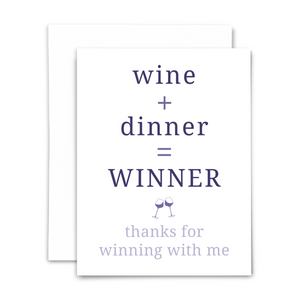 Blank greeting card "wine + dinner = winner; thanks for winning with me" in purple font on white background; with white envelope
