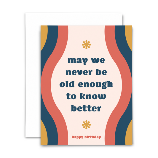 Birthday blank greeting card 'may we never be old enough to know better ~ happy birthday' mid century navy font blush background with coral navy and gold vertical wavy stripes; with white envelope