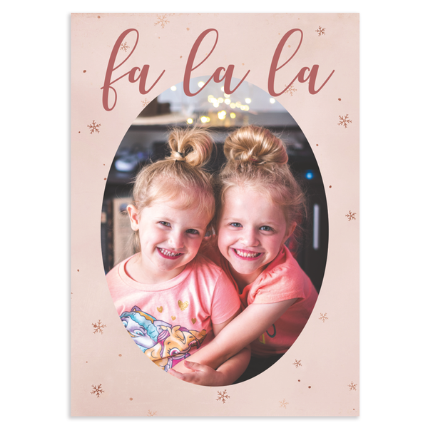 Custom holiday photo card, fa la la in script font across oval photo on pink background with snowflakes